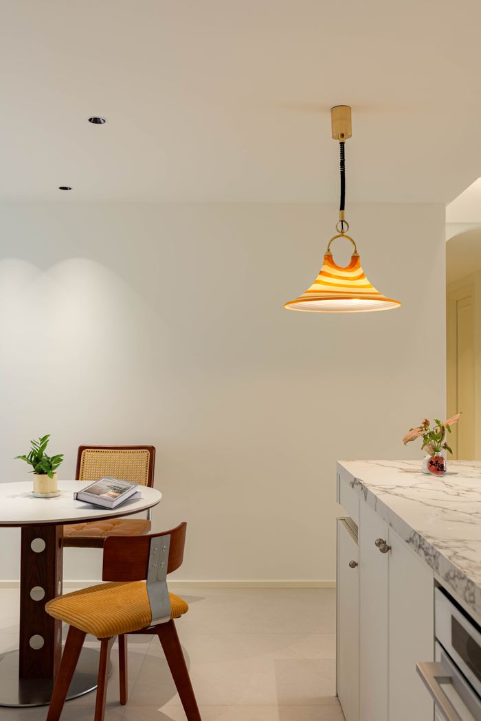 Modern kitchen interior featuring marble and chic decor elements.